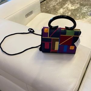 This dark navy purse is perfect for any occasion, it has a tassel on one side!